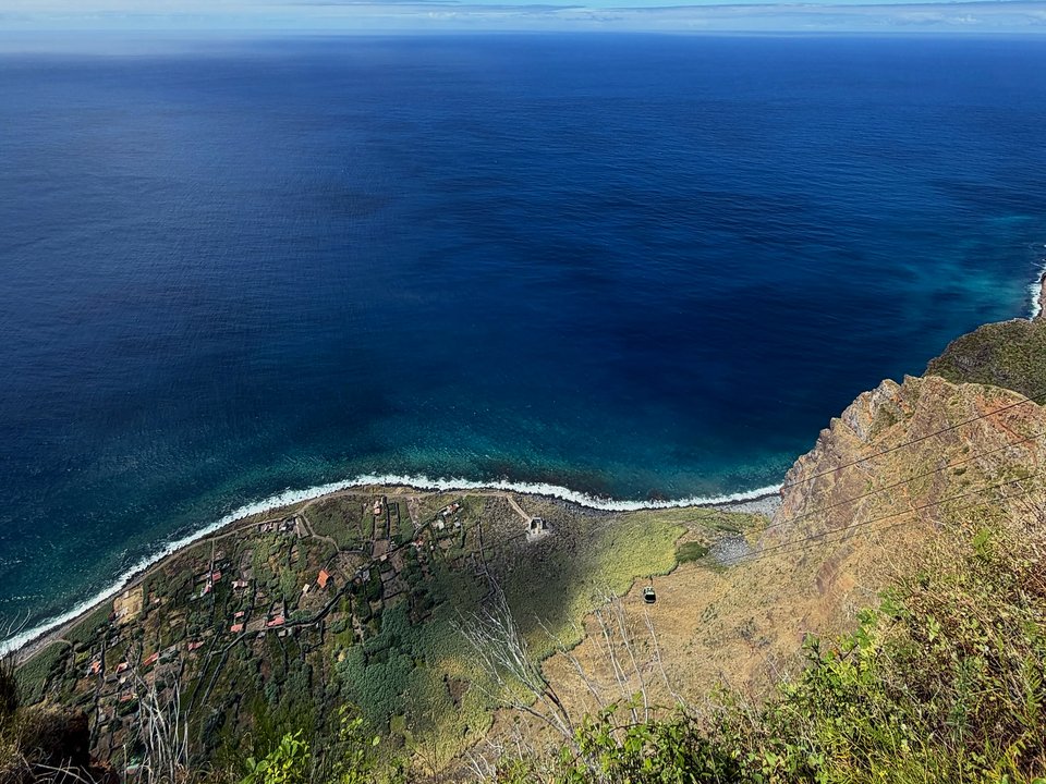 Vertical cliff walls and coastal panorama framed from the historic trail to the fajã