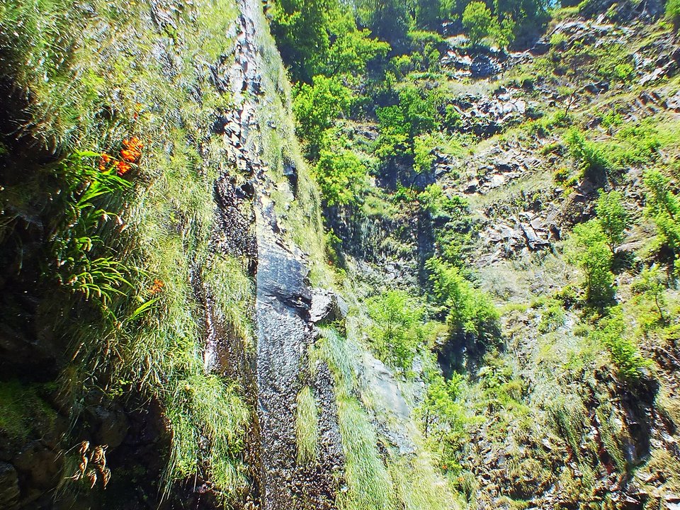 Masonry water channel and inspection path of Levada da Água de Alto near Ribeira da Abelheira in Santana