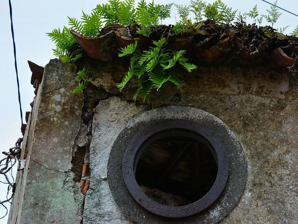Open stone irrigation channel of Levada da Azenha contouring above the Caniço valley