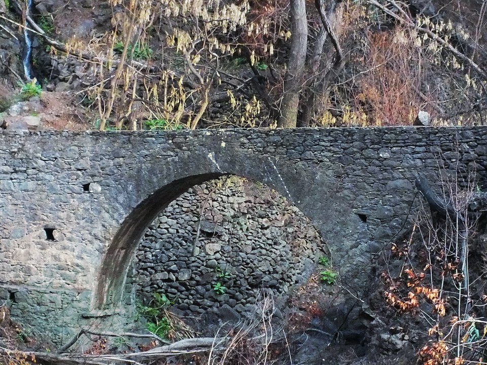 Masonry water channel and inspection path of Levada do Caniço near Ribeira do Porto Novo in Santa Cruz