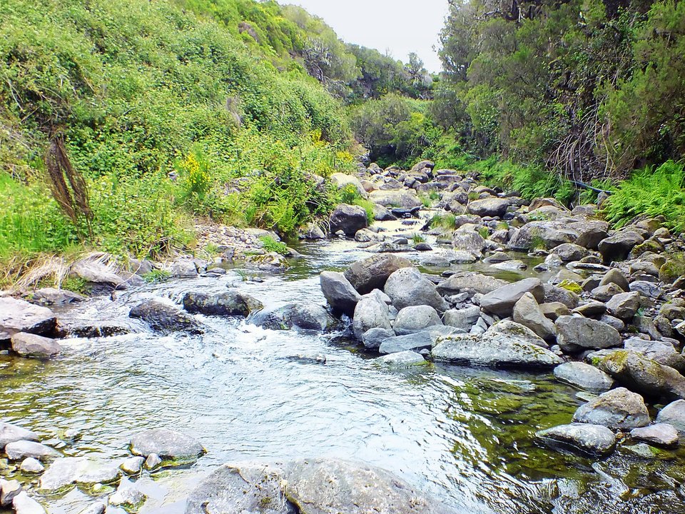 Masonry water channel and inspection path of Levada do Lajeado near Ribeira Grande in Paul da Serra