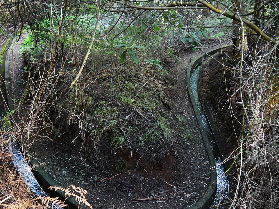 Masonry water channel and inspection path of Levada Nova, Santo da Serra near Ribeira de Santa Cruz