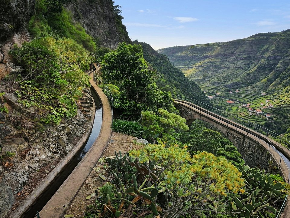Lush canyon vegetation and natural water cascades along the Tábua levada