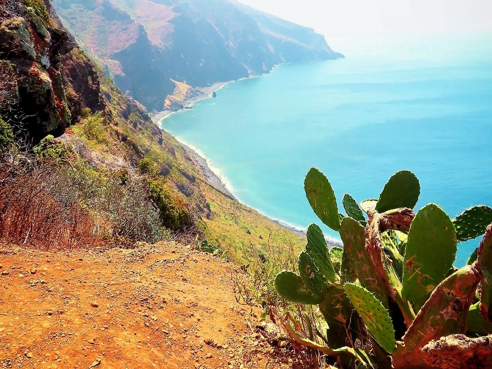 Coastal cliff edge and sweeping ocean horizon from Miradouro do Fio to Ponta do Pargo Lighthouse
