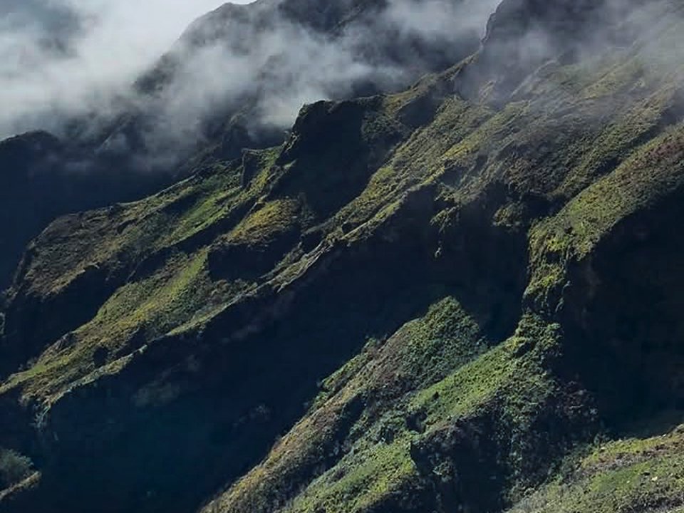 Panoramic sunrise view over the volcanic ridge and jagged crags of Pico do Areeiro on PR 1
