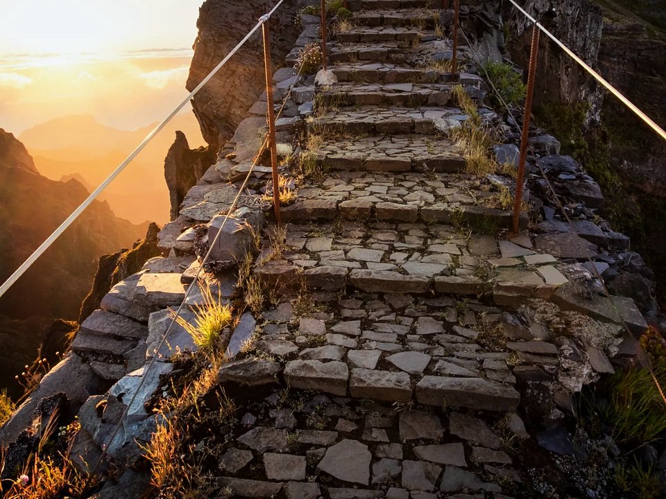 Stepped alpine trail traversing along the knife-edge ridge of Vereda do Areeiro