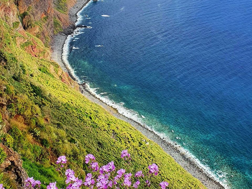 Historic stone pathway etched into volcanic bluffs above the southwestern coast