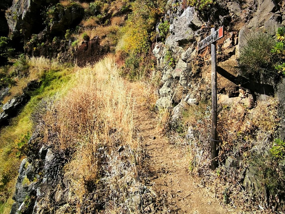 Dramatic basalt switchbacks descending the southwest sea cliffs toward the shoreline