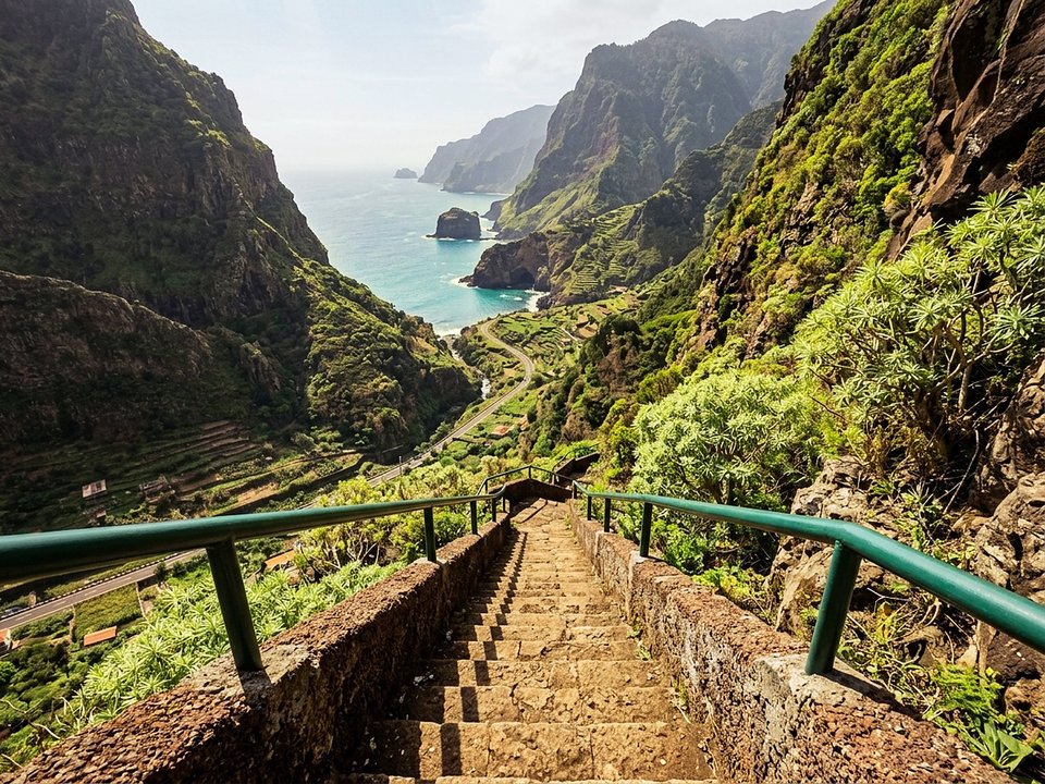Wild rocky footpath leading to sea caves and volcanic arches near Porto Moniz