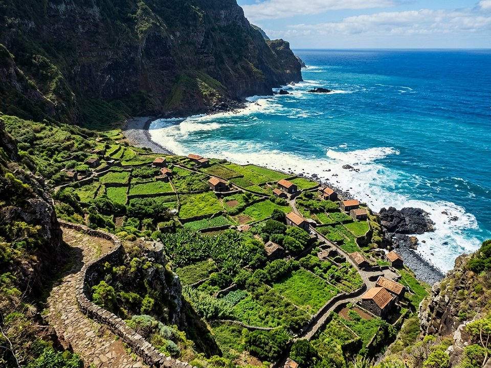 Panoramic cliff trail vista overlooking the agricultural stone cottages of Fajã da Quebrada Nova