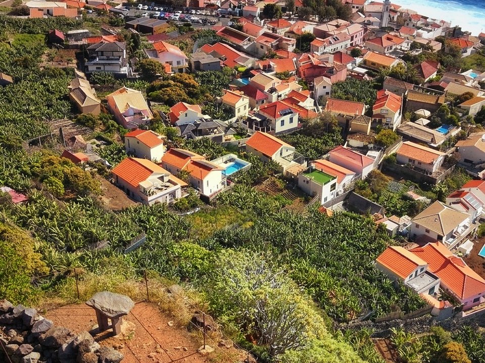 Historic stone-paved zigzags descending the red volcanic cliff toward Jardim do Mar