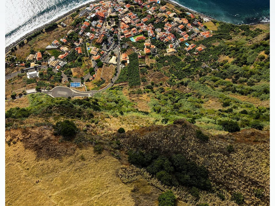 Dramatic sea cliffs and terraced agricultural poios hanging high above the Atlantic