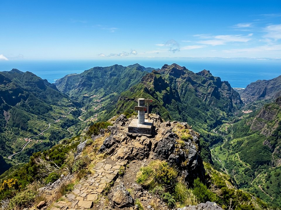 Weathered summit trig marker and expansive moorland views from Pico Ruivo do Paul